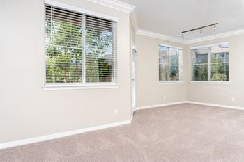 A bedroom with three windows